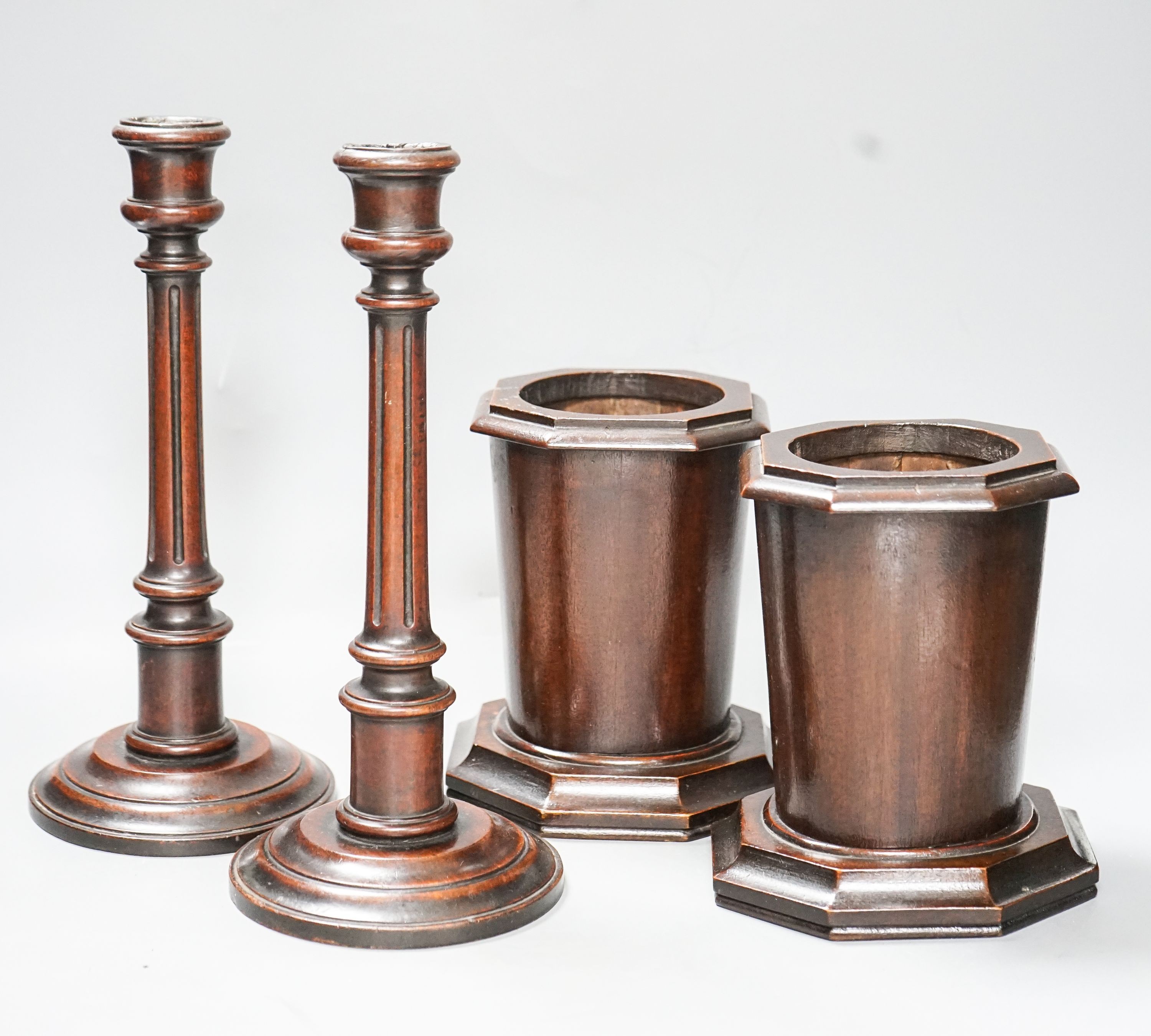 A pair of Victorian fluted mahogany candlesticks and a pair of mahogany spill vases 29cm